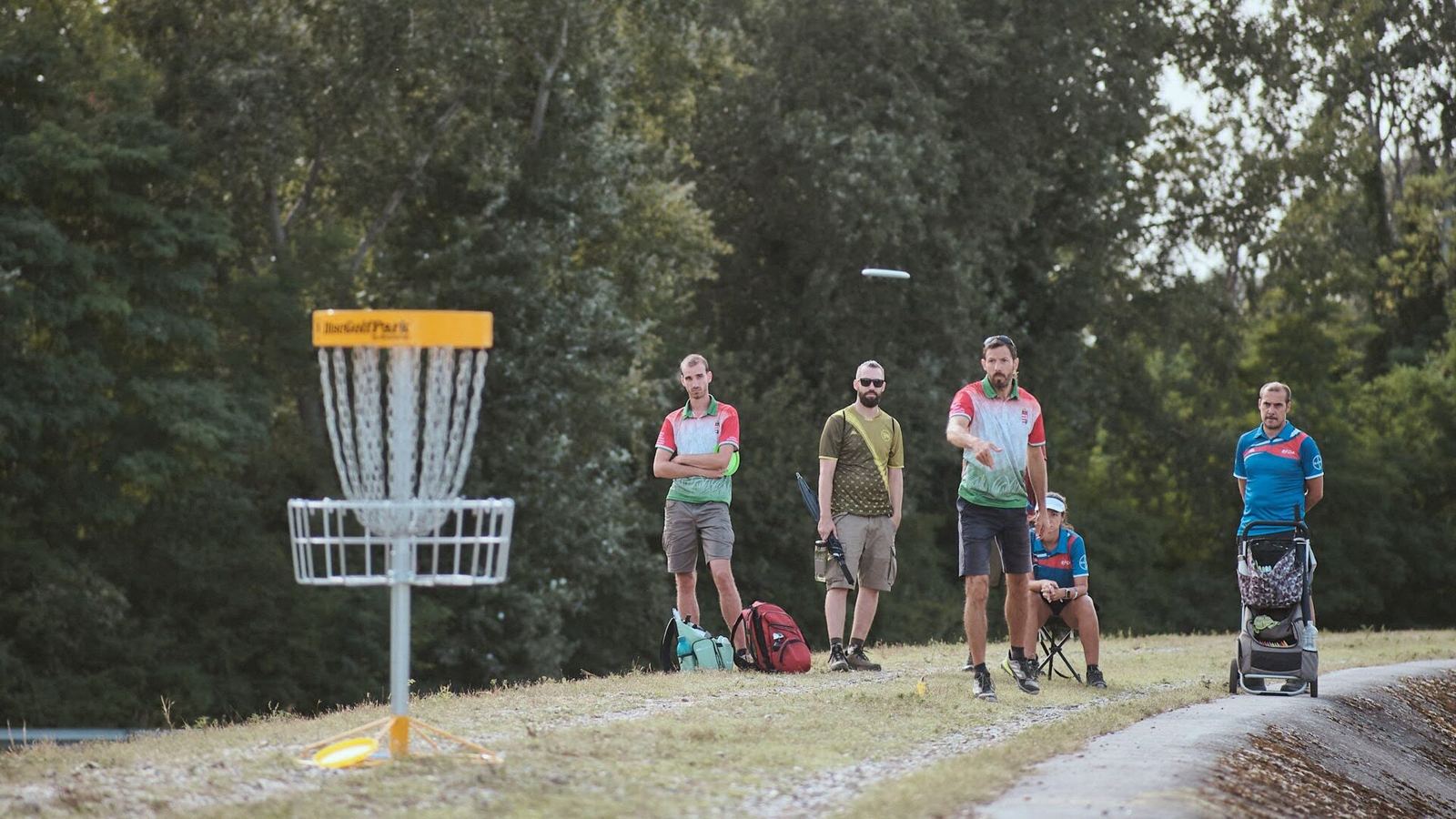 Players and spectators at a basket during the 2022 World Team Disc Golf Championship